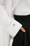 WHITE LOOSE-FIT COTTON SHIRT WITH UKRAINIAN FLAG EMBROIDERY