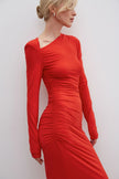 Red midi dress with gathers made of knit fabric.