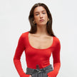 Red knitted bodysuit with a round neckline